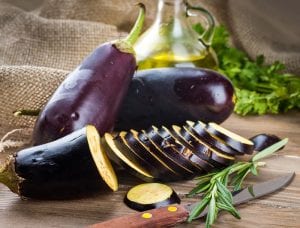 Eggplant and olive oil on a wooden board