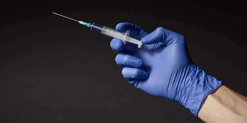 Hand with syringe