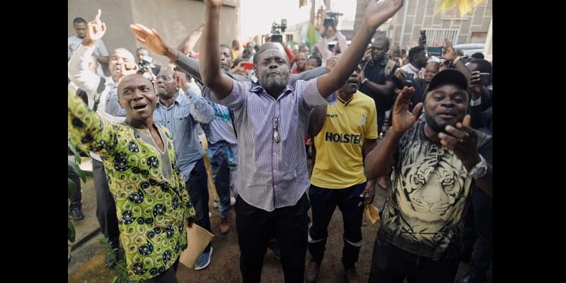 Supporters of Maurice Kamto of Renaissance Movement (MRC) react after his news conference at his headquarter in Yaounde,