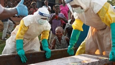A mother of a child, suspected of dying from Ebola, cries near her child’s coffin in Beni