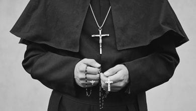priest with crucifix