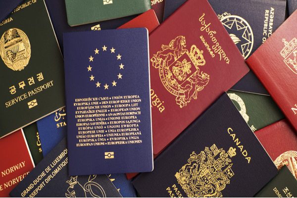 Mixed-biometric-passports-of-many-countries-of-the-world.-In-the-foreground-is-a-European-Union-passport.