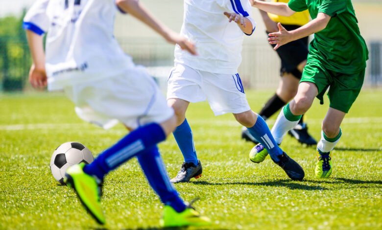 Soccer tournament for youth teams. Young boys playing football soccer match.