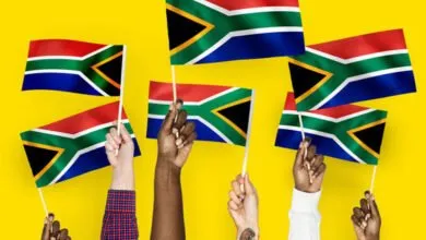 Hands waving flags of South Africa